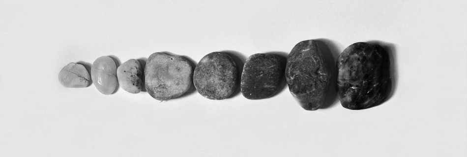 row of black and gray polished pebble on gray surface