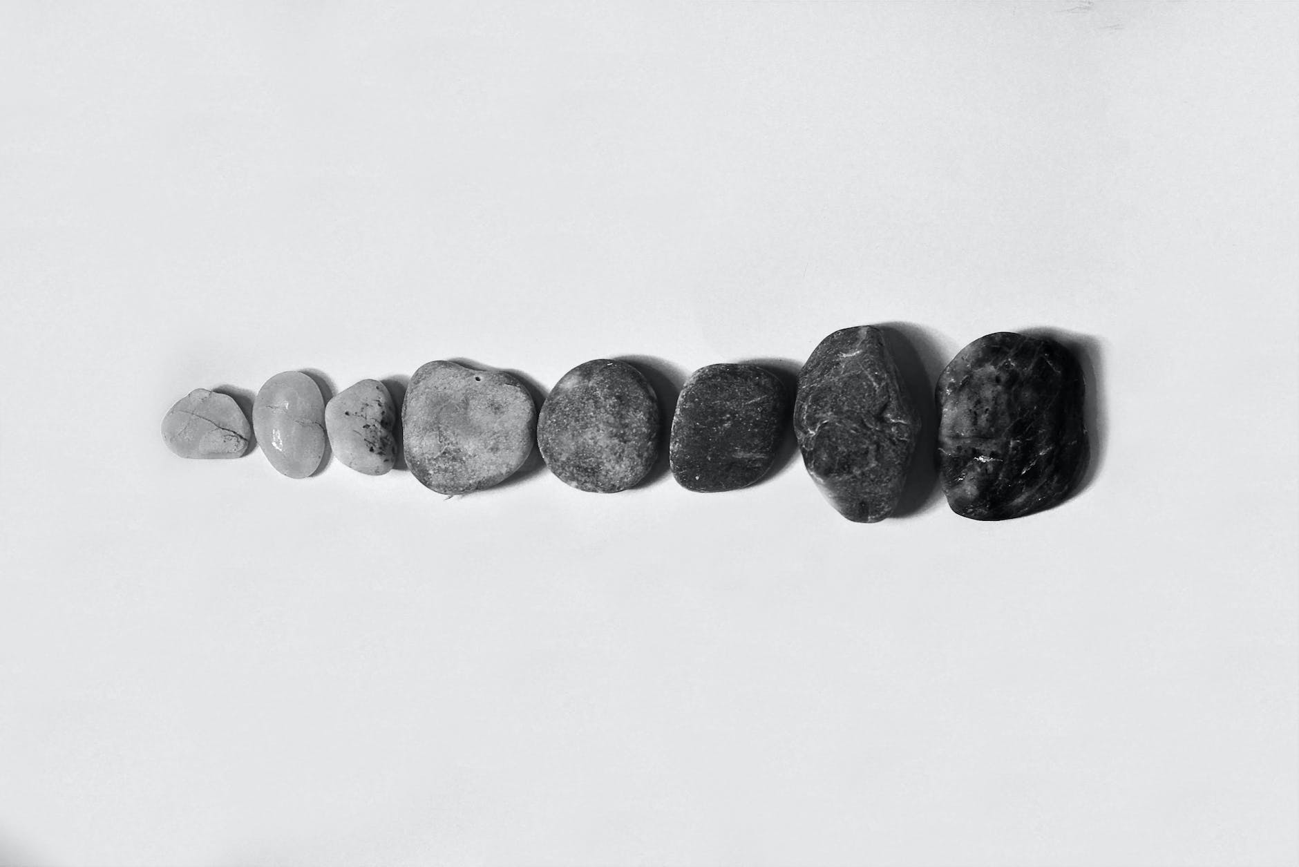 row of black and gray polished pebble on gray surface